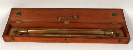 A MORRISON BROTHERS, GLASGOW, BRASS INSTRUMENT in a wooden box. 24ins.