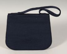 A CARTIER BLUE BAG, the inside with a mirror. 9ins long in an original Cartier box.