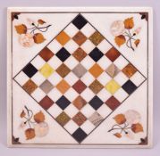 AN ITALIAN SQUARE MARBLE CHESS BOARD, inlaid with specimen marbles with mother of pearl flowers.