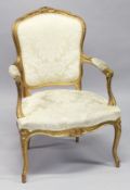 A LATE 19TH CENTURY / EARLY 20TH CENTURY FRENCH GILTWOOD FAUTEUIL, upholstered in a classical