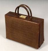 A REVLON BROWN LEATHER BAG with fitted interior. 12ins long