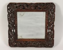 A GOOD CHINESE CARVED AND PIERCED MIRROR with dragons and foliage. 11.5ins x 11.5ins