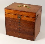 A 19TH CENTURY MAHOGANY COLLECTION CABINET the rising top with fitted interior on six gadrooned