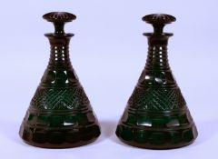 A PAIR OF CUT GLASS GREEN SHIP'S DECANTERS AND STOPPERS.