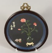 A CHINESE ROSEWOOD FRAMED PICTURE with vase etc. in jade. 7ins diameter.