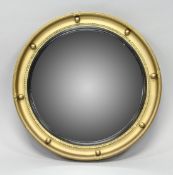 A REGENCY STYLE GILT FRAMED CONVEX MIRROR. 1ft 5.5ins diameter.
