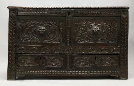 AN 18TH CENTURY OAK COFFER, with a plain plank top, pair of carved panels to the front, with