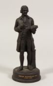 A BLACK JASPERWARE MODEL OF JOSIAH WEDGWOOD FRS, (1730 - 1795). 8.5ins high.