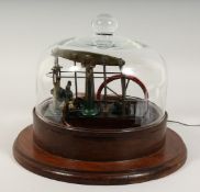 A MODEL STEAM ENGINE in a circular glass dome