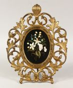 A VERY GOOD ITALIAN PIETRA DURA OVAL PLAQUE OF FLOWERS. 5ins x 3.5ins in a good gilt metal frame.