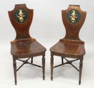 A VERY GOOD PAIR OF 19TH CENTURY MAHOGANY HALL CHAIRS, with shield shaped backs having a painted and
