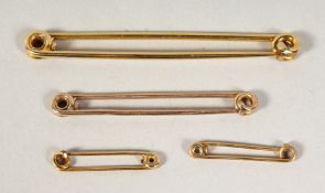 FOUR ASPREY 9CT GOLD PINS in an Asprey's box. 11gms.