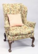 A GOOD GEORGE II DESIGN WALNUT AND UPHOLSTERED WING ARMCHAIR, with floral upholstery on four well