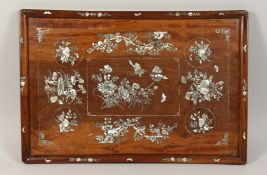 A CHINESE RECTANGULAR ROSEWOOD PANEL inlaid with mother of pearl almond blossom. 14ins x 22ins.