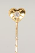 A DIAMOND SET HEART TIE PIN, cased.