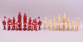 A GOOD 19TH CENTURY CHINESE CARVED AND STAINED RED AND WHITE IVORY CHESS SET, each piece on a carved