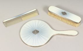 A SILVER AND ENAMEL HAND MIRROR, COMB AND BRUSH (4). London 1899