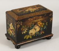 A VICTORIAN PAPIER MACHE TWO DIVISION TEA CADDY gilt decoration painted with flowers. 7ins long.