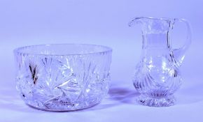 A HEAVY CUT GLASS BOWL AND JUG.