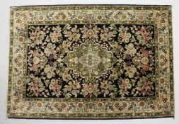 A PERSIAN DESIGN PART SILK RUG, black ground with all over floral decoration. 5ft x 3ft 6ins.