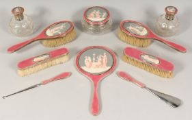 A GOOD SILVER DRESSING TABLE SET with classical scenes comprising; hand mirror, 2 scent bottles,