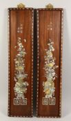 A GOOD PAIR OF CHINESE ROSEWOOD LONG PANELS inlaid with mother of pearl vases and flowers. 31ins x
