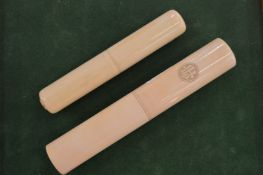 Two tube shaped boxes.