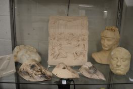 A collection of plaster plaques, wall masks etc.