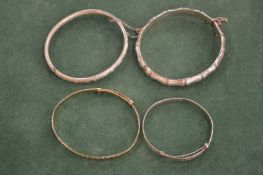 Four silver bangles.