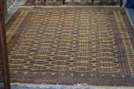 A large modern Bokhara style carpet.