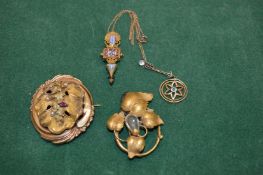 A decorative gilt metal brooch and other items.