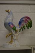 A large porcelain model of a cockerel.
