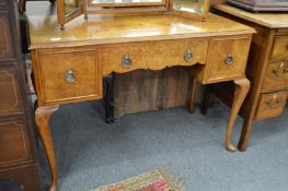 A figured walnut dressing table.