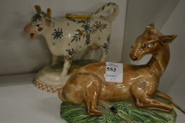 A Staffordshire pottery deer and cow creamer.
