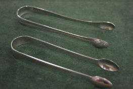 TWO GEORGE III BRIGHT CUT SUGAR TONGS, S A London 1784.
