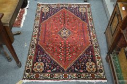 A small Persian rug with floral decoration.
