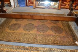 A gold ground Afghan style rug.