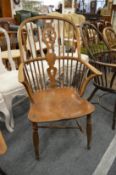 A 19th century ash and elm wheel back armchair.