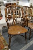 A 19th century yew and elm Windsor wheel back armchair.