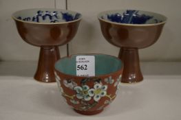 A Chinese tea bowl and two stem cups.
