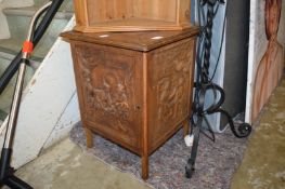 An oak storage box with carved decoration.