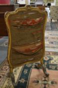 A carved gilt framed fire screen.