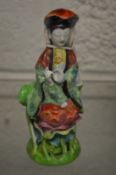 A small Chinese figure of a woman.