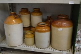 A quantity of stoneware flagons and jars.