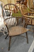 An 18th century or earlier hoop back Windsor armchair.