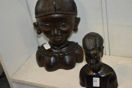 Two carved African busts.