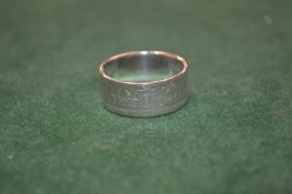 An unusual coin made from a 1954 shilling, size V.