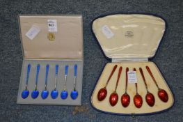 Two cased sets of Scandinavian enamelled silver coffee spoons (faults).