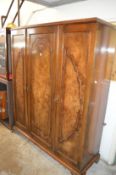 A walnut triple wardrobe.