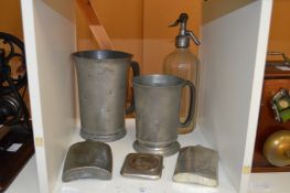 Large pewter tankards and other items.